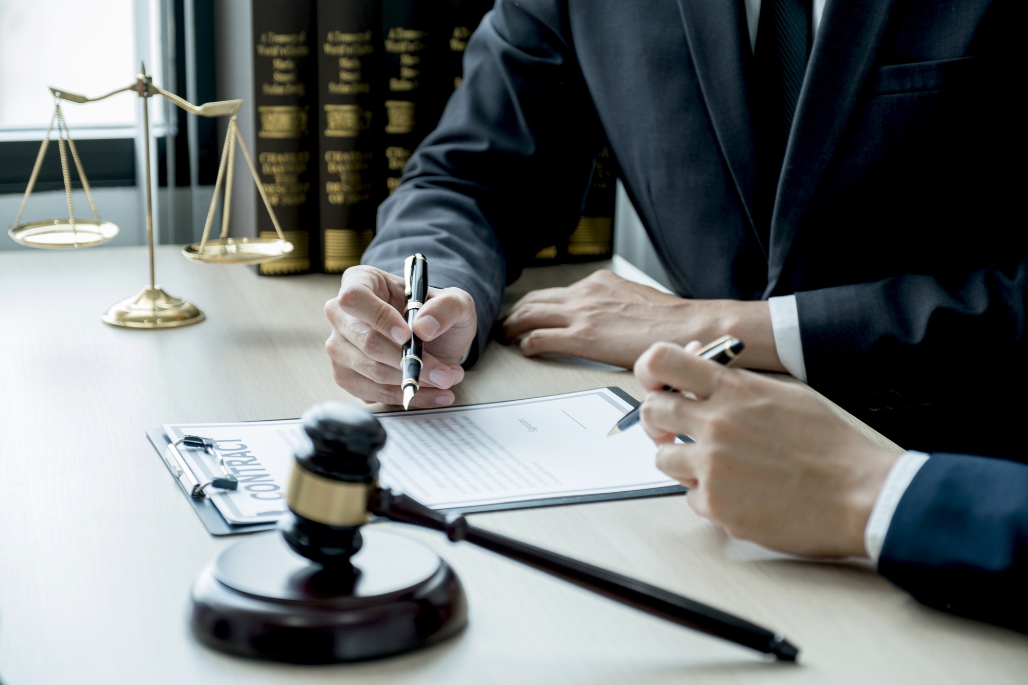 Lawyer hand holding pen and providing legal consult business dispute to the man